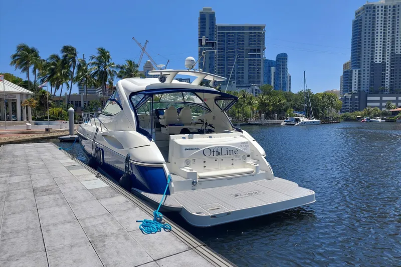 Slide: The Image of Luxury 2006 Cruisers Yachts 520 Express docked in a scenic urban marina. - 5