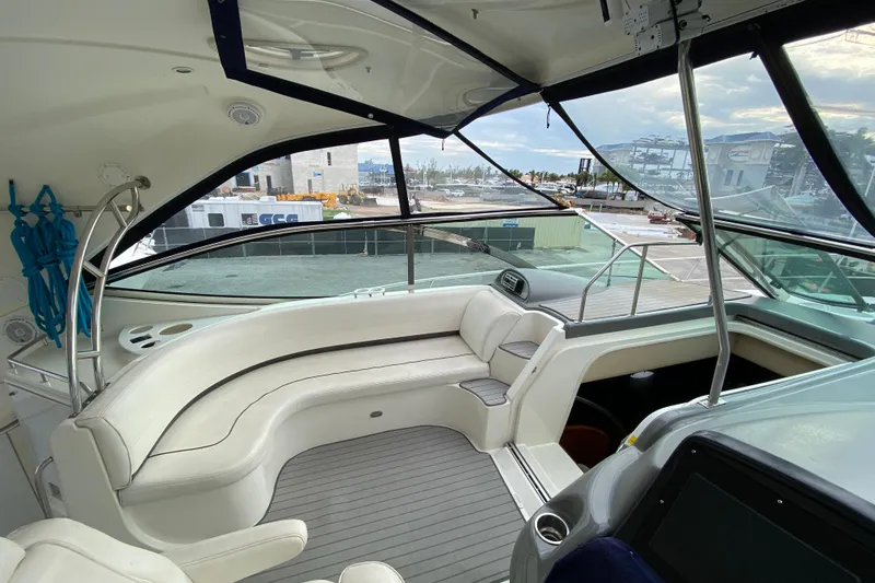 Slide: The Image of 2006 Cruisers Yachts 520 Express kitchen with wooden cabinetry and compact refrigerator. - 60