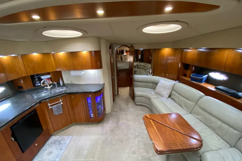 Slide: The Image of Luxurious 2006 Cruisers Yachts 520 Express cabin with bed, TV, and ensuite bathroom. - 67
