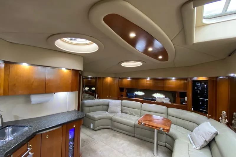 Slide: The Image of Luxurious 2006 Cruisers Yachts 520 Express cabin interior with bed, TV, and wooden finishes. - 68