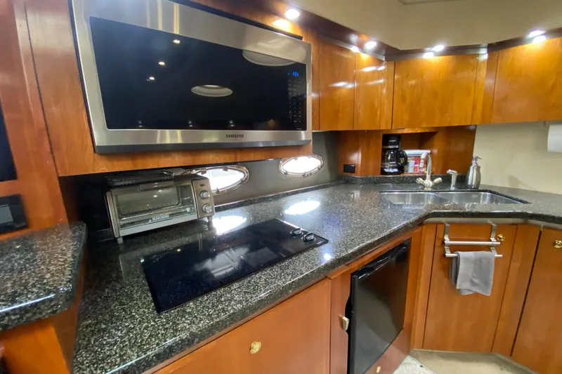 Slide: The Image of Luxurious 2006 Cruisers Yachts 520 Express bedroom with elegant bedding and ambient lighting. - 69