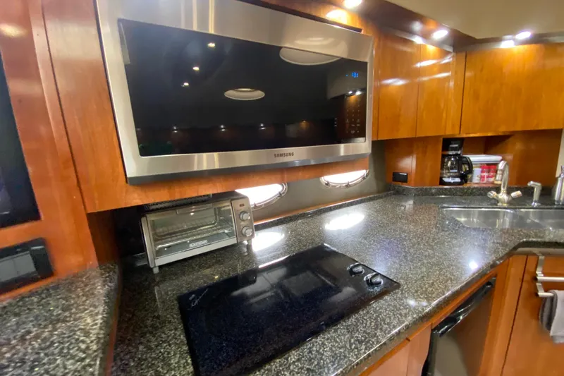 Slide: The Image of Luxurious bedroom interior of 2006 Cruisers Yachts 520 Express with cozy bedding and elegant wood finish. - 70