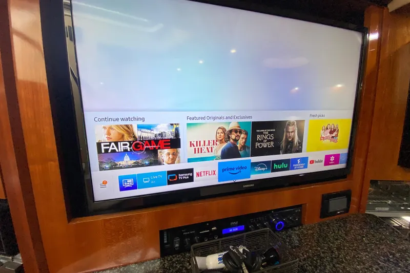 Slide: The Image of 2006 Cruisers Yachts 520 Express interior closet with hangers and wooden finish. - 74