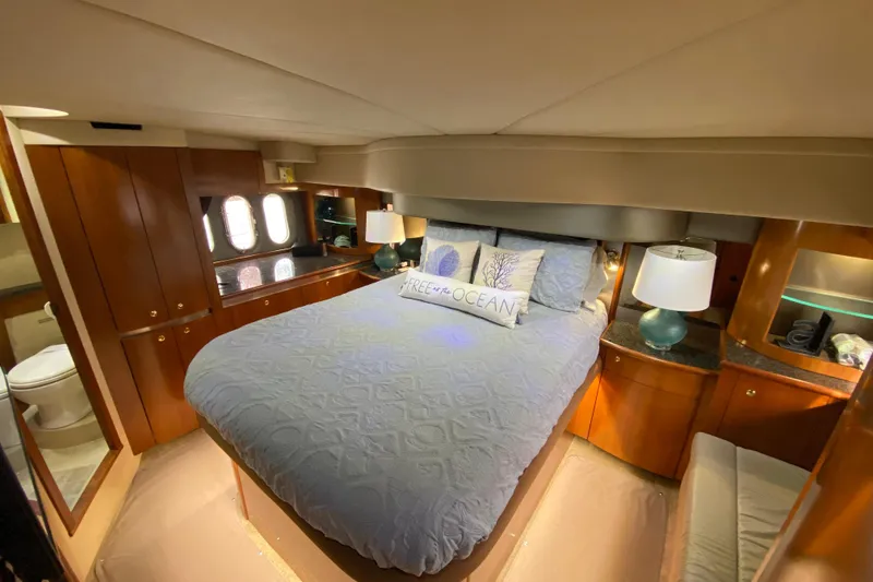 Slide: The Image of Luxurious bathroom in 2006 Cruisers Yachts 520 Express, featuring wood accents and modern fixtures. - 77