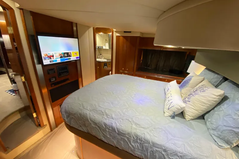 Slide: The Image of Luxurious cabin interior of 2006 Cruisers Yachts 520 Express with cozy bed and nautical decor. - 78