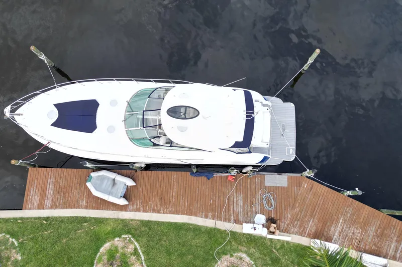 Slide: The Image of Aerial view of 2006 Cruisers Yachts 520 Express docked at a wooden pier. - 8