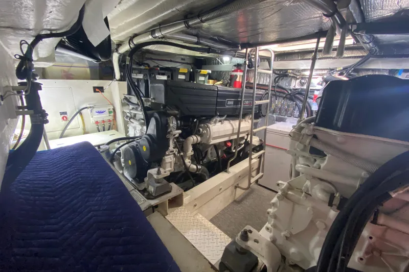 Slide: The Image of Engine compartment of 2006 Cruisers Yachts 520 Express showing trim tab pump and wiring. - 101