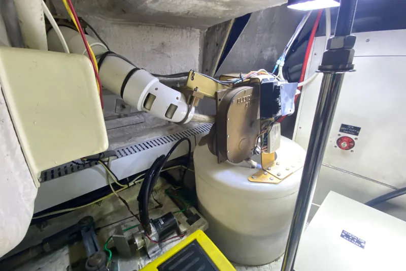 Slide: The Image of Engine room of 2006 Cruisers Yachts 520 Express, showcasing mechanical components and insulation. - 102