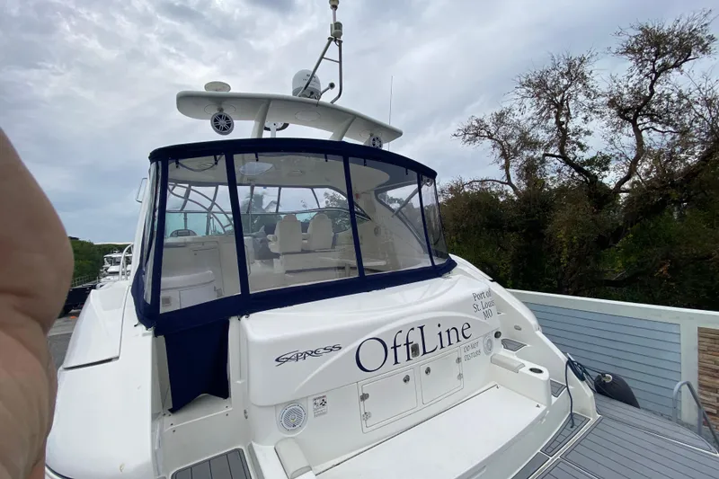 Slide: The Image of 2006 Cruisers Yachts 520 Express docked, rear view with canopy and seating area. - 11