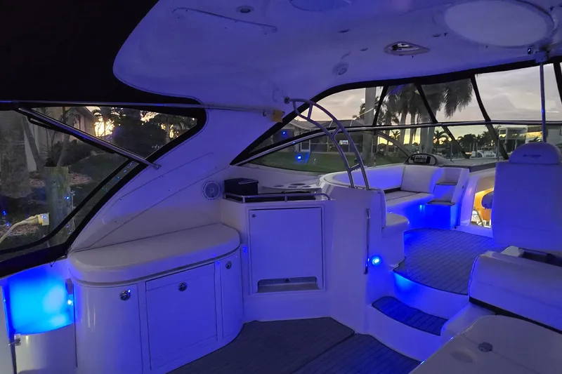 Slide: The Image of 2006 Cruisers Yachts 520 Express interior with blue ambient lighting at sunset. - 17