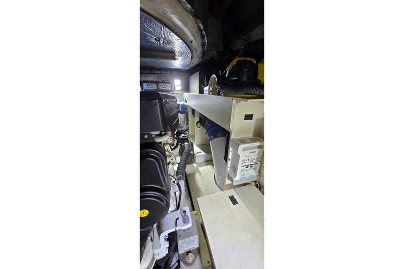 Slide: The Image of 2006 Cruisers Yachts 520 Express on a serene waterfront with sun loungers. - 32