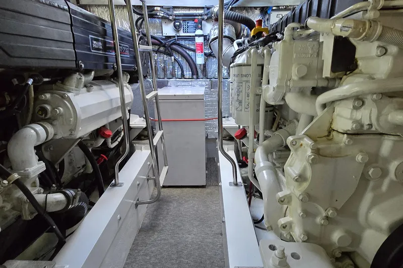 Slide: The Image of 2006 Cruisers Yachts 520 Express with blue sun pads on deck, docked by waterfront. - 33