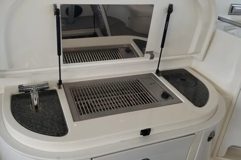 Slide: The Image of 2006 Cruisers Yachts 520 Express storage area with ropes, life jacket, and "Do Not Disturb" sign. - 35