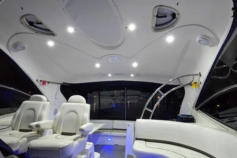 Slide: The Image of 2006 Cruisers Yachts 520 Express interior with white seating and panoramic windows. - 49