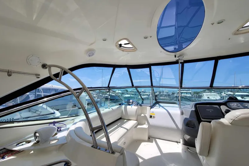 Slide: The Image of Interior of 2006 Cruisers Yachts 520 Express, featuring spacious seating and modern amenities. - 50