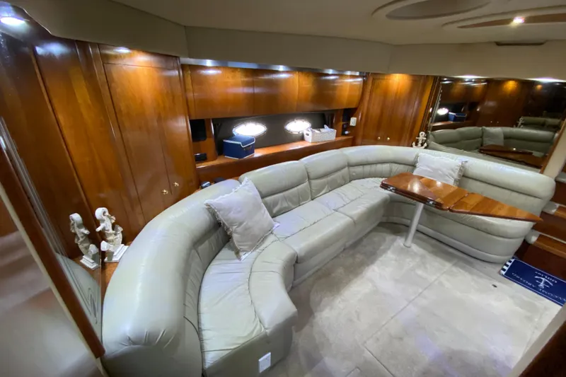 Slide: The Image of Luxurious 2006 Cruisers Yachts 520 Express bedroom with elegant wood cabinetry and cozy bedding. - 66