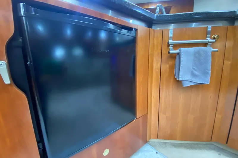Slide: The Image of Interior of 2006 Cruisers Yachts 520 Express with TV and bathroom view. - 71