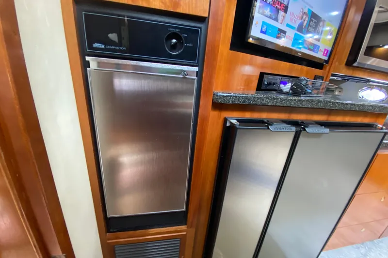 Slide: The Image of Front-loading washing machine in wooden cabinet on 2006 Cruisers Yachts 520 Express. - 72