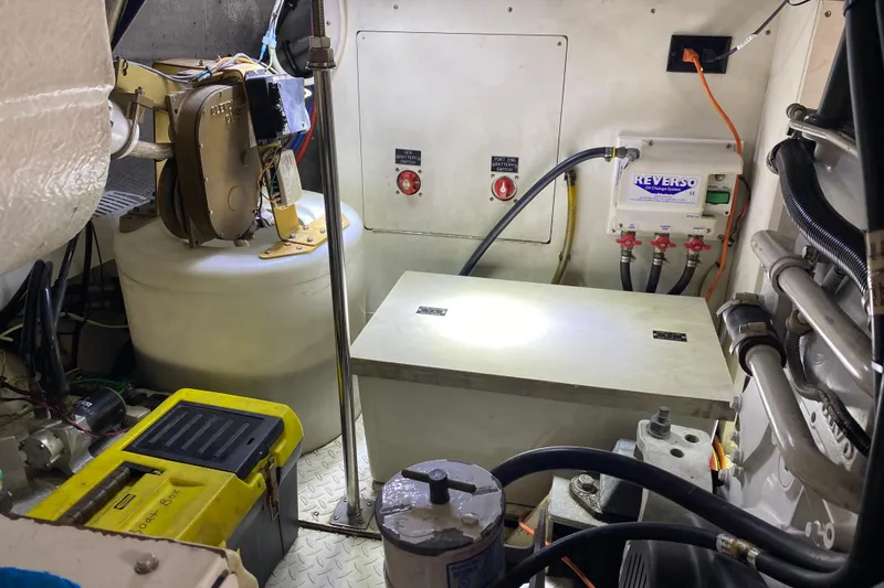 Slide: The Image of Battery compartment of a 2006 Cruisers Yachts 520 Express, showing wiring and connections. - 97