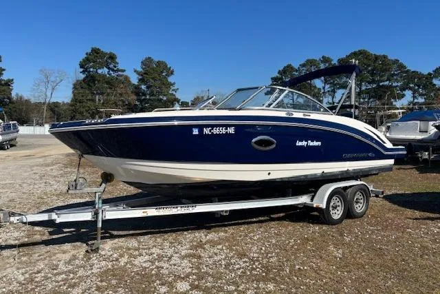 Slide: The Image of 2018 Chaparral 230 Suncoast boat interior with white seating and cup holders. - 15