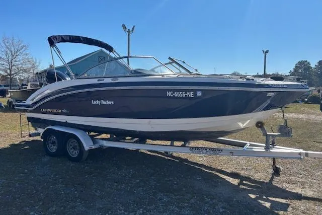 Slide: The Image of 2018 Chaparral 230 Suncoast boat interior with steering wheel and seating. - 16
