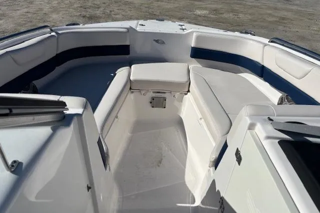 Slide: The Image of 2018 Chaparral 230 Suncoast boat interior with white captain's seat and steering wheel. - 22
