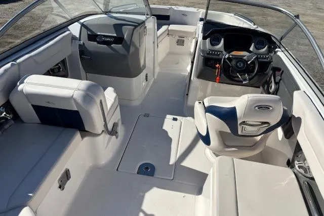 Slide: The Image of 2018 Chaparral 230 Suncoast boat interior with cushioned seating and sleek design. - 23