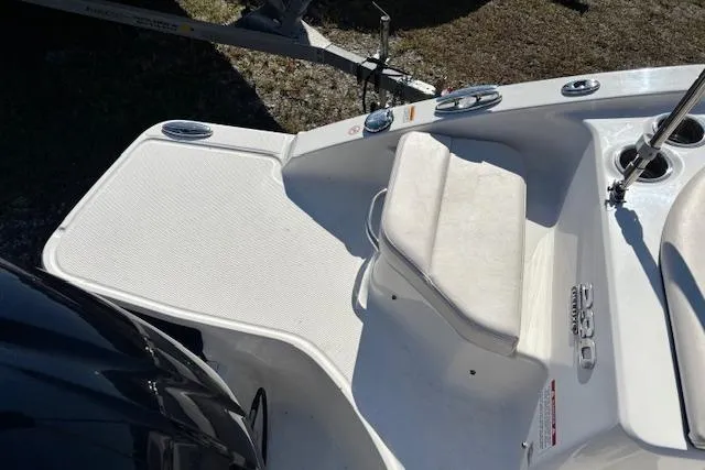 Slide: The Image of 2018 Chaparral 230 Suncoast boat interior with white and blue seating. - 25