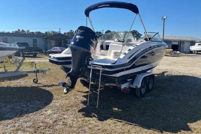 Slide: The Image of 2018 Chaparral 230 Suncoast boat on trailer, outdoor setting, clear sky. - 6
