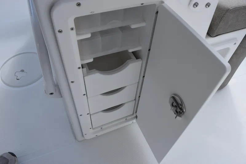 Slide: The Image of Open storage compartment on 2026 Sea Hunt Ultra 255 SE boat. - 17