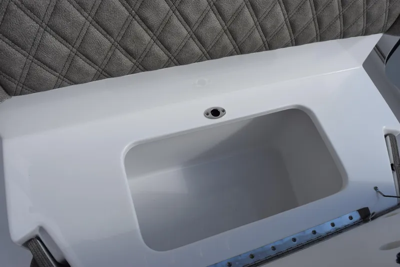 Slide: The Image of 2026 Sea Hunt Ultra 255 SE boat interior with cushioned seating and storage compartment. - 18