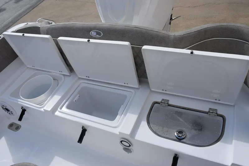 Slide: The Image of 2026 Sea Hunt Ultra 255 SE boat storage compartments with open lids, showcasing interior features. - 20