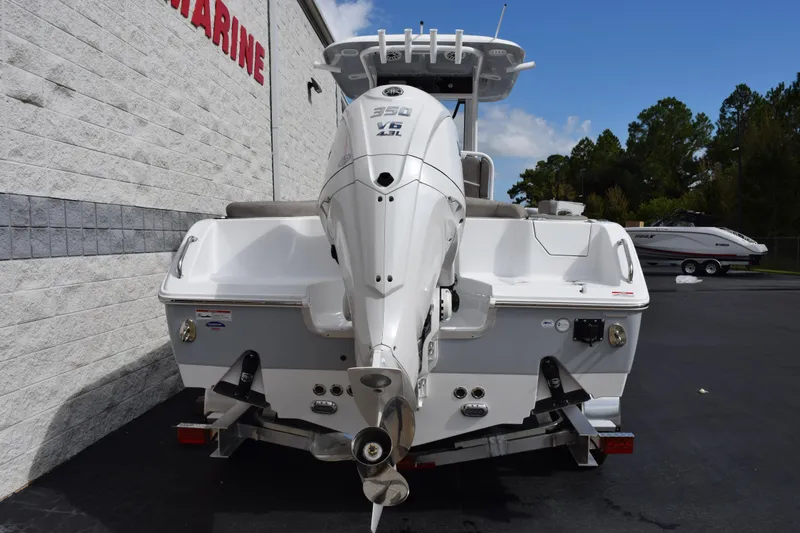Slide: The Image of 2026 Sea Hunt Ultra 255 SE boat with powerful outboard motor, parked outdoors. - 5