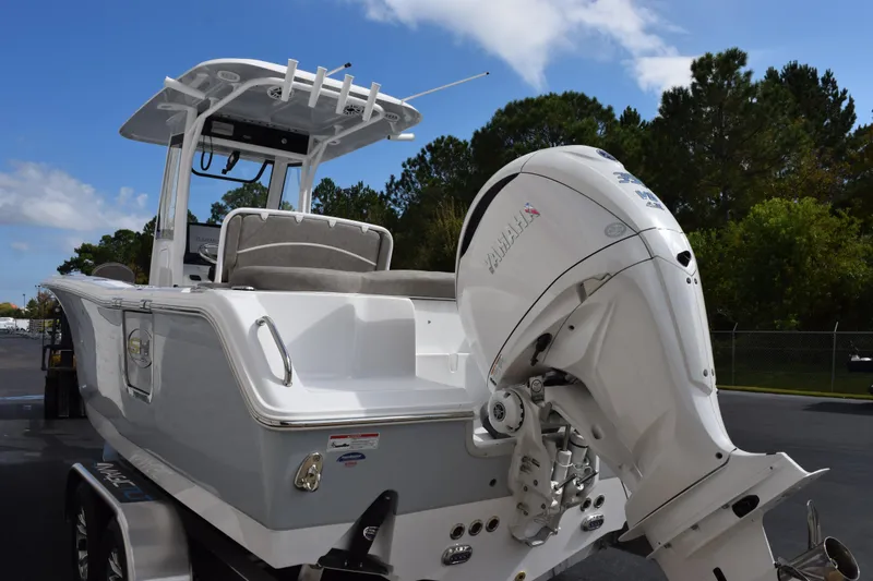 Slide: The Image of 2026 Sea Hunt Ultra 255 SE boat with Yamaha outboard motor, parked outdoors. - 6