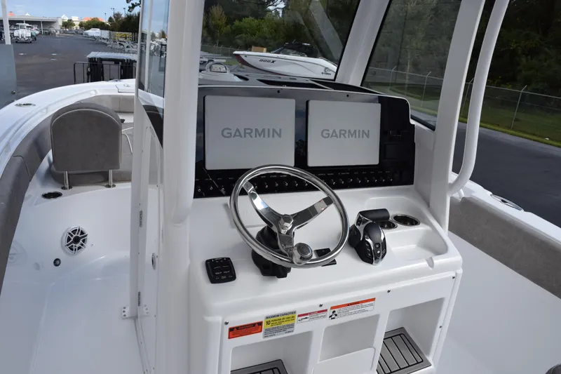 Slide: The Image of 2026 Sea Hunt Ultra 255 SE boat dashboard with Garmin navigation displays. - 9