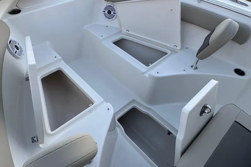 Slide: The Image of 2026 Key West 244 Center Console boat interior with storage compartments and seating. - 11