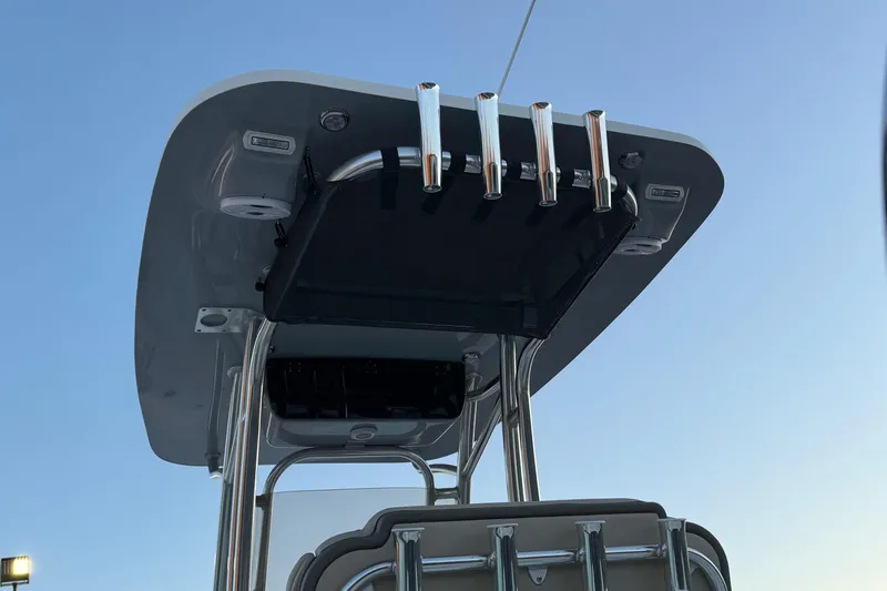 Slide: The Image of T-top of 2026 Key West 244 Center Console boat with rod holders against clear sky. - 5
