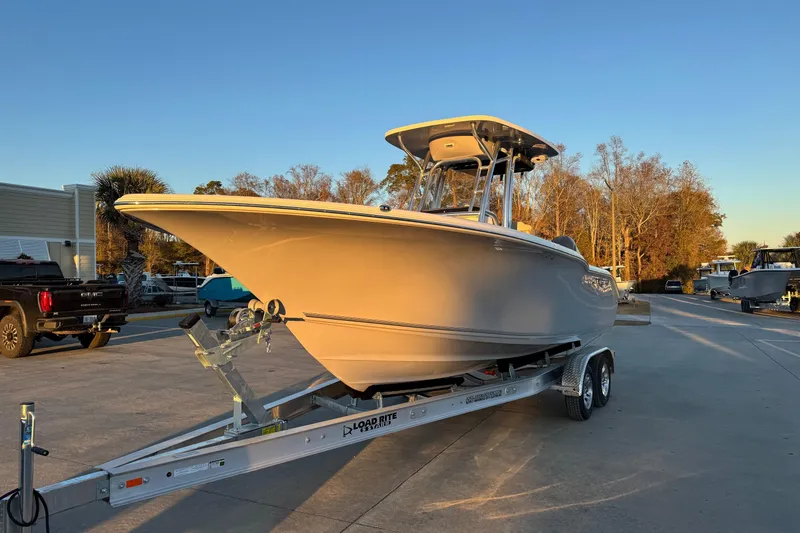 The Image of 2026 Key West 244 Center Console boat on trailer in sunny outdoor setting. - 1