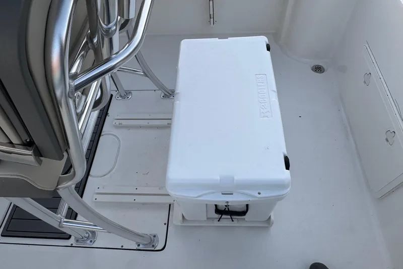 Slide: The Image of 2026 Key West 244 Center Console deck with cooler and seating area. - 21