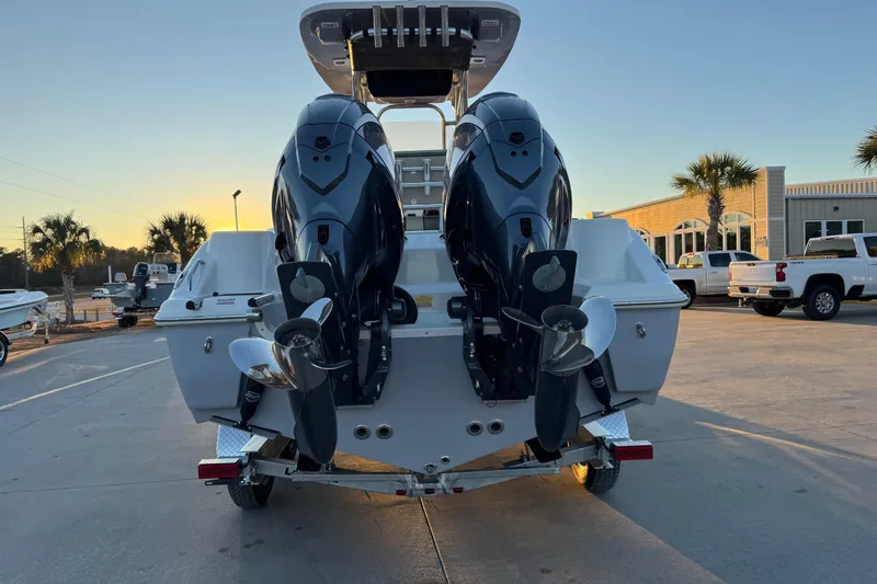 Slide: The Image of 2026 Key West 244 Center Console boat with dual outboard motors at sunset. - 4