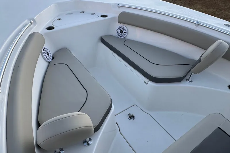 Slide: The Image of 2026 Key West 244 Center Console boat interior with cushioned seating and speakers. - 10