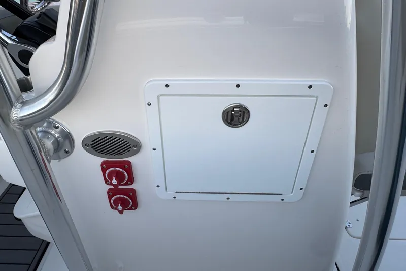 Slide: The Image of 2026 Key West 244 Center Console boat dashboard with controls and storage compartment. - 13