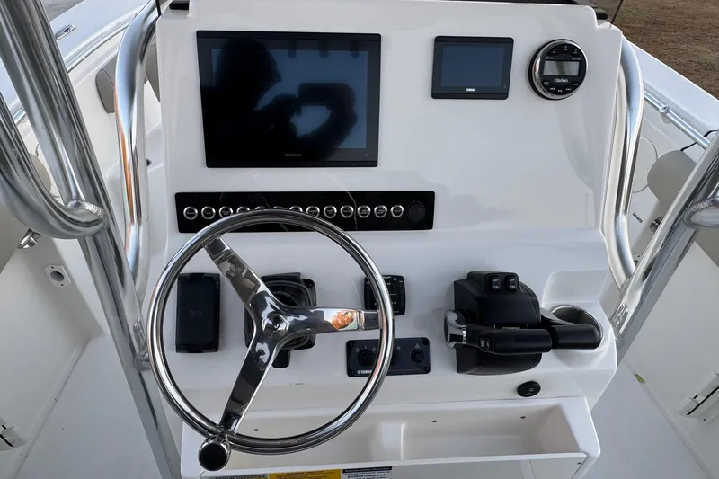 Slide: The Image of Center console of 2026 Key West 244 boat with steering wheel and electronic displays. - 17