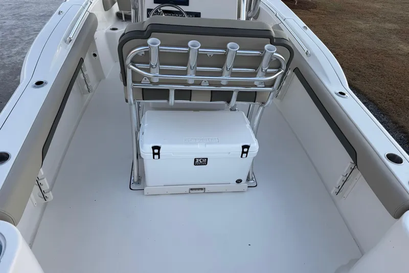 Slide: The Image of 2026 Key West 244 Center Console boat interior with seating and cooler. - 7