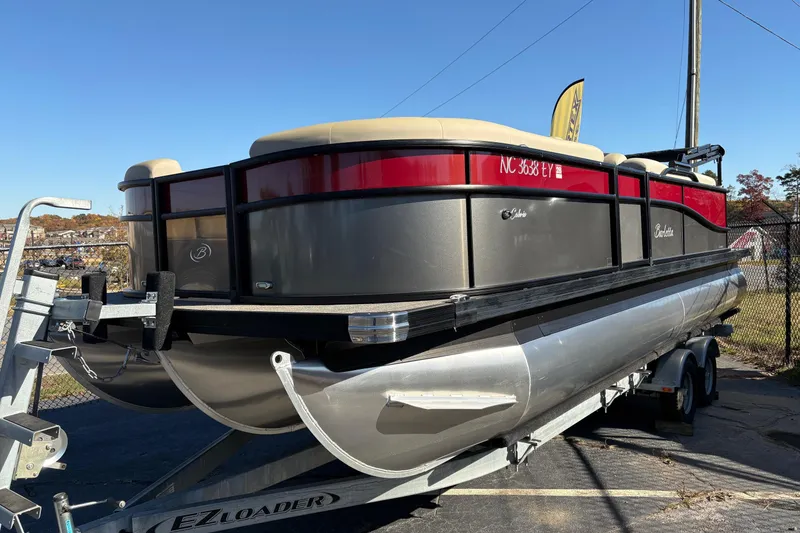Slide: The Image of 2022 Barletta Cabrio 22Q pontoon boat on trailer, sunny day background. - 1
