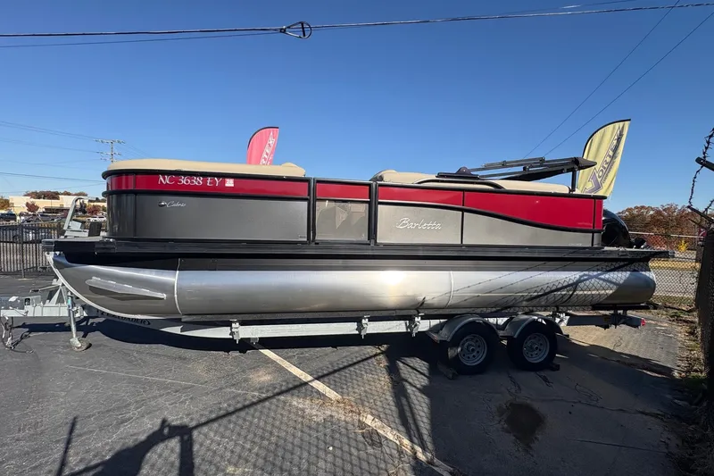 Slide: The Image of 2022 Barletta Cabrio 22Q pontoon boat on trailer, parked outdoors. - 3