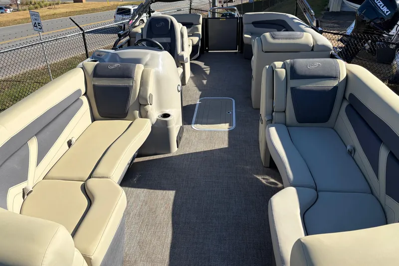 Slide: The Image of 2022 Barletta Cabrio 22Q pontoon boat interior with beige seating and steering console. - 4