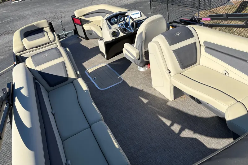 Slide: The Image of 2022 Barletta Cabrio 22Q pontoon boat interior with beige seating and modern dashboard. - 5