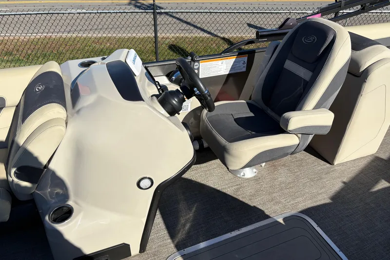 Slide: The Image of 2022 Barletta Cabrio 22Q boat interior with steering wheel and captain's chair. - 9