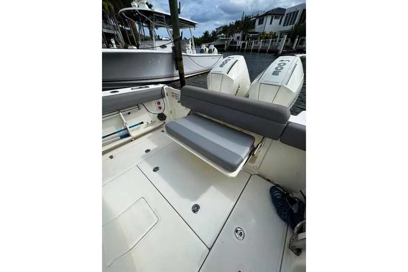 Slide: The Image of 2024 Boston Whaler 280 Outrage boat interior with seating and twin engines. - 12